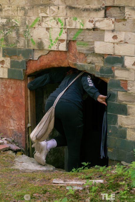 Redhead model Cherr explores abandoned building and pleasures herself with flogger